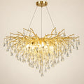 Gold branch crystal chandelier on a warm studio background