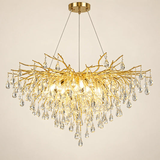 Gold branch crystal chandelier on a warm studio background