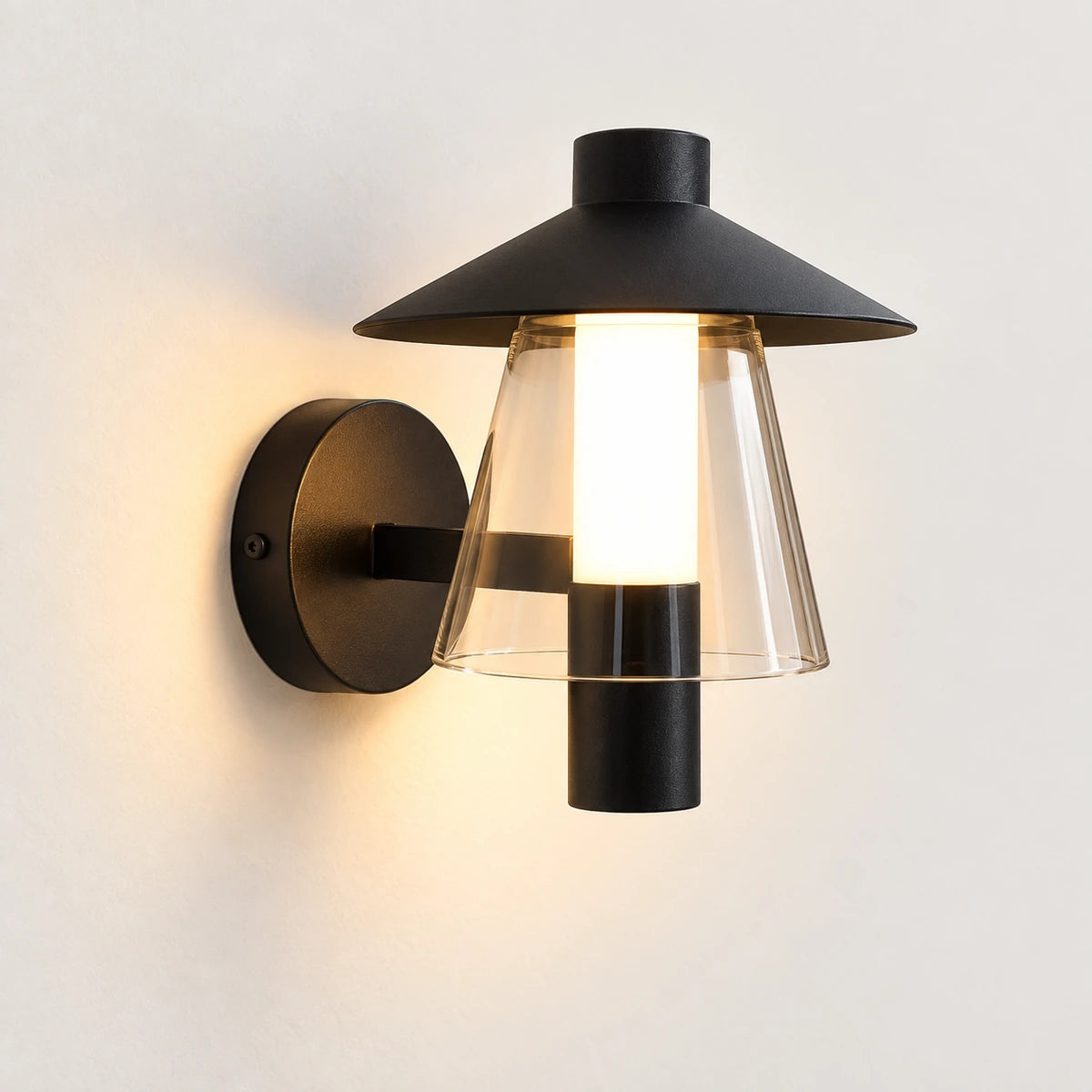 Black hooded outdoor wall light with clear tapered acrylic skirt