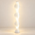 Illustration of sculptural three-wave floor lamp; stated height 140 cm; scene and light output illustrative