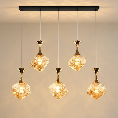 Five-light faceted amber glass cluster pendant on a black linear canopy