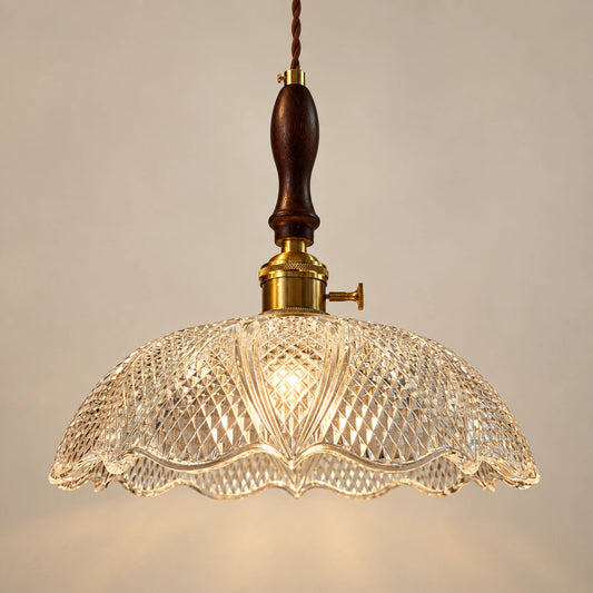 Diamond-cut clear glass dome pendant with dark wood spindle and warm metal fitting