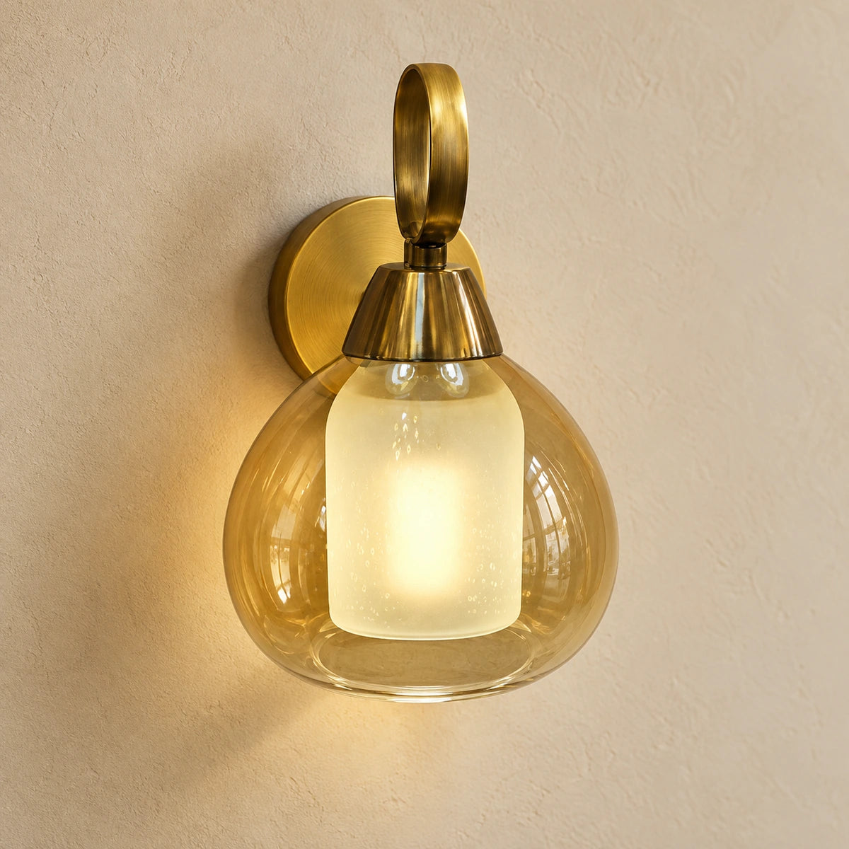 Amber nested-glass wall sconce with looped antique-brass mount