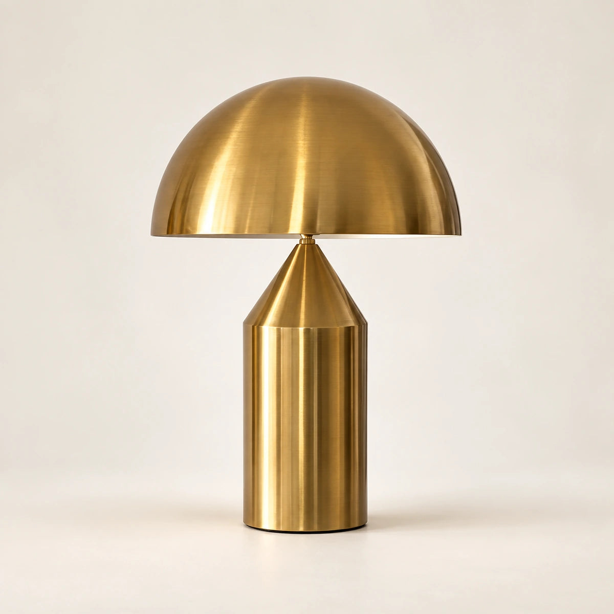 Antique-gold dome table lamp with broad metal shade and cylindrical base