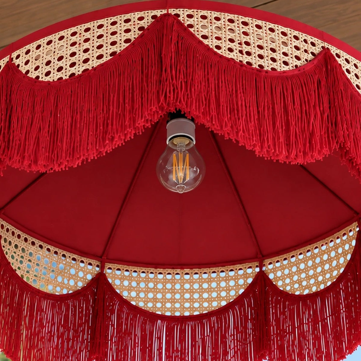 Close-up of the layered cane weave and scalloped red fringe