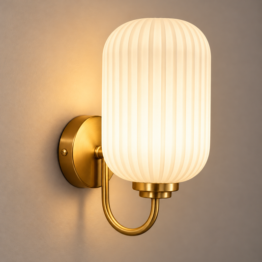 Ribbed white capsule shade with a gold-tone loop arm and round wall plate