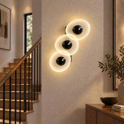 Triple oval illuminated wall art in a hallway
