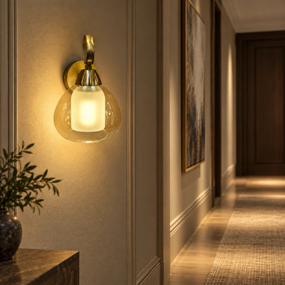 Amber nested-glass wall sconce illuminating a hallway