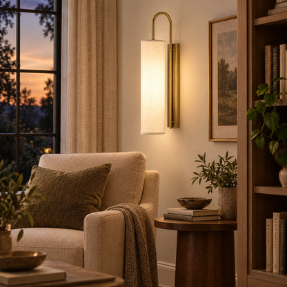 Tall cylinder shade wall sconce in a living room reading corner