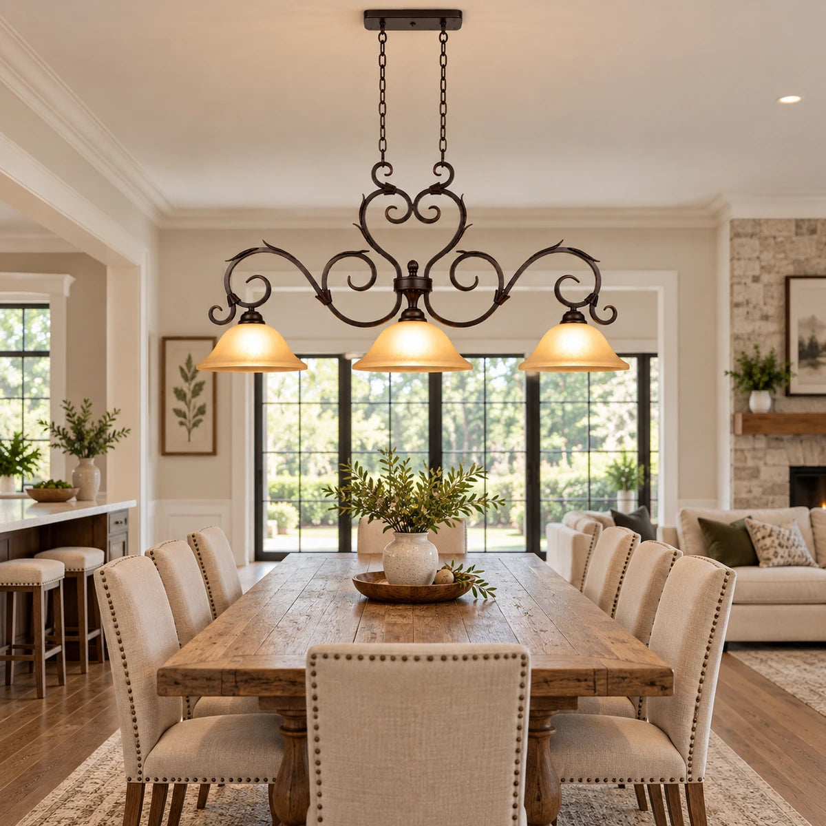 Antique-scroll three-shade linear pendant in an open-plan dining room