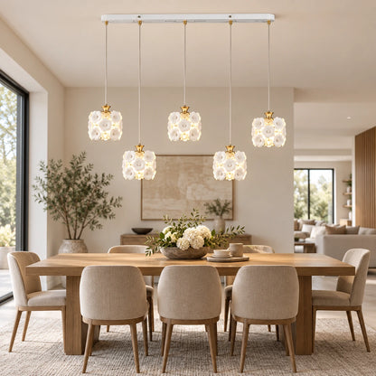 Floral ceramic five-shade pendant cluster in an open-plan dining room