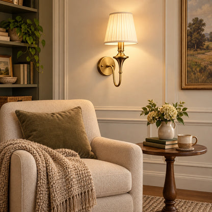 Tapered shade wall sconce illuminating an indoor reading corner