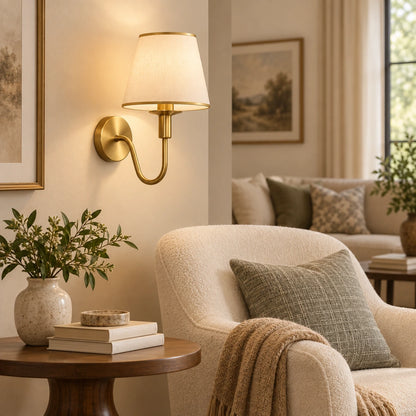 Curved arm shaded wall sconce in a living room reading corner