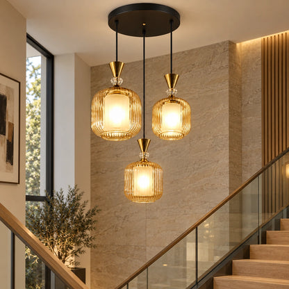 Amber-glass three-light pendant cluster over a stairwell
