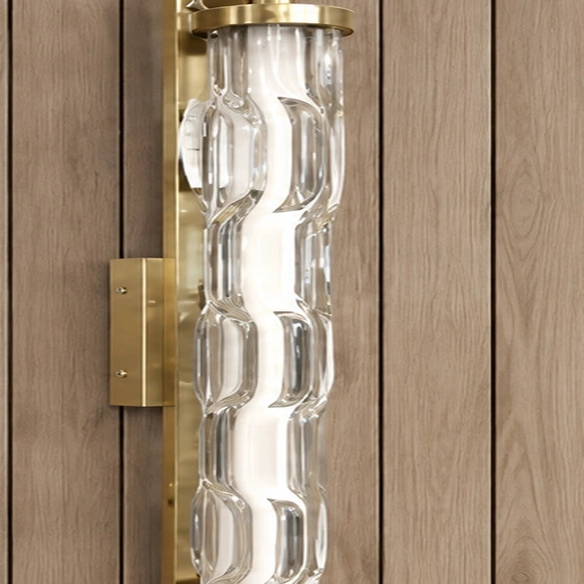 Detail of sculpted clear glass and brushed-gold fittings