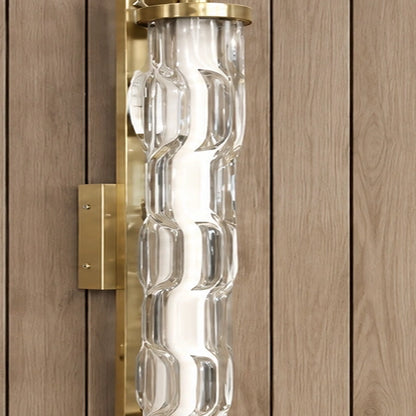 Detail of sculpted clear glass and brushed-gold fittings