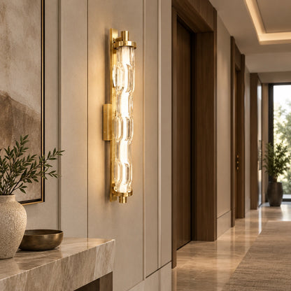 Sculpted clear-glass gold wall light in a hallway