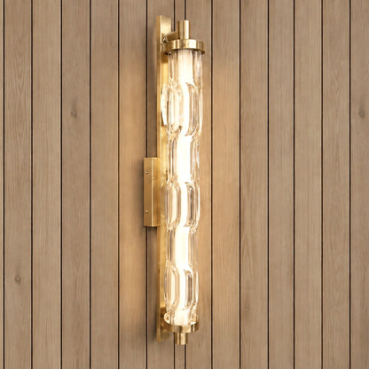Sculpted clear-glass gold wall light illuminated