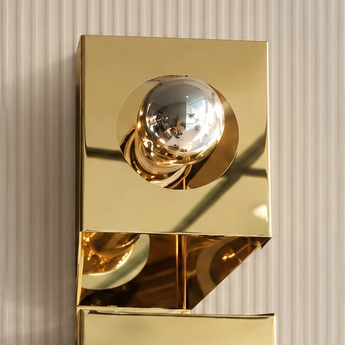 Close-up of the reflective upper globe and polished gold housing