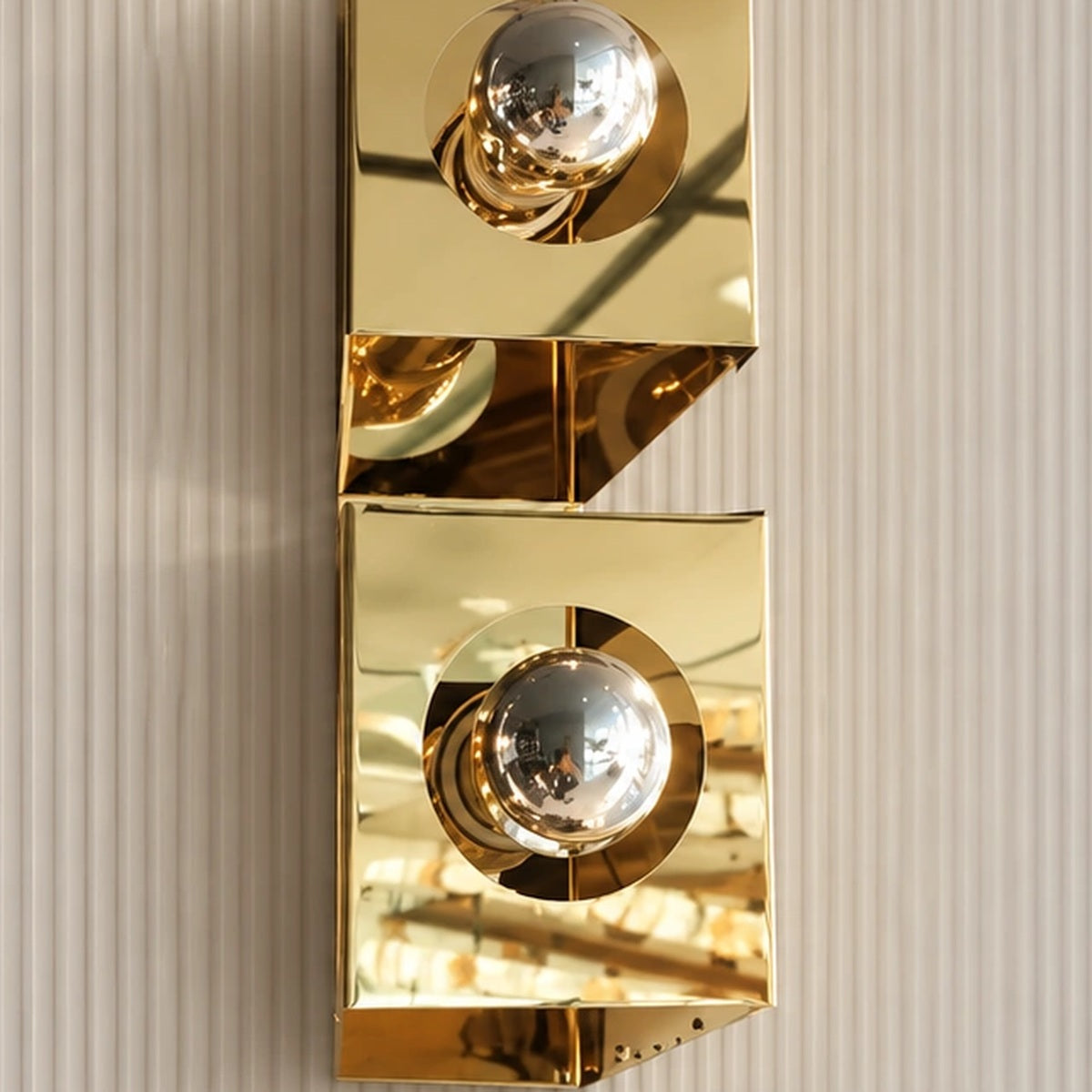 Full fixture detail of the stacked geometric gold wall light