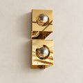 Sculptural twin-globe polished gold wall light, full product hero