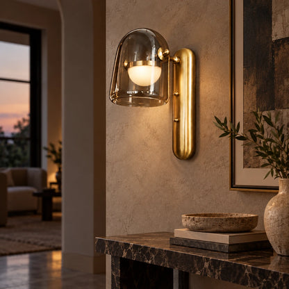 Smoked glass and brushed-gold wall light in a hallway
