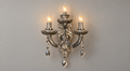 Smoked ornate wall light with three candle-style forms