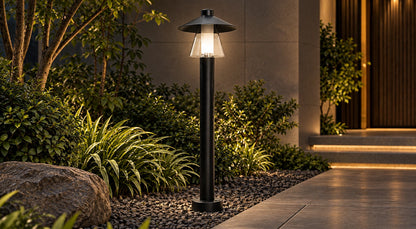 Halo Lantern matte-black bollard light illuminating a garden path at night