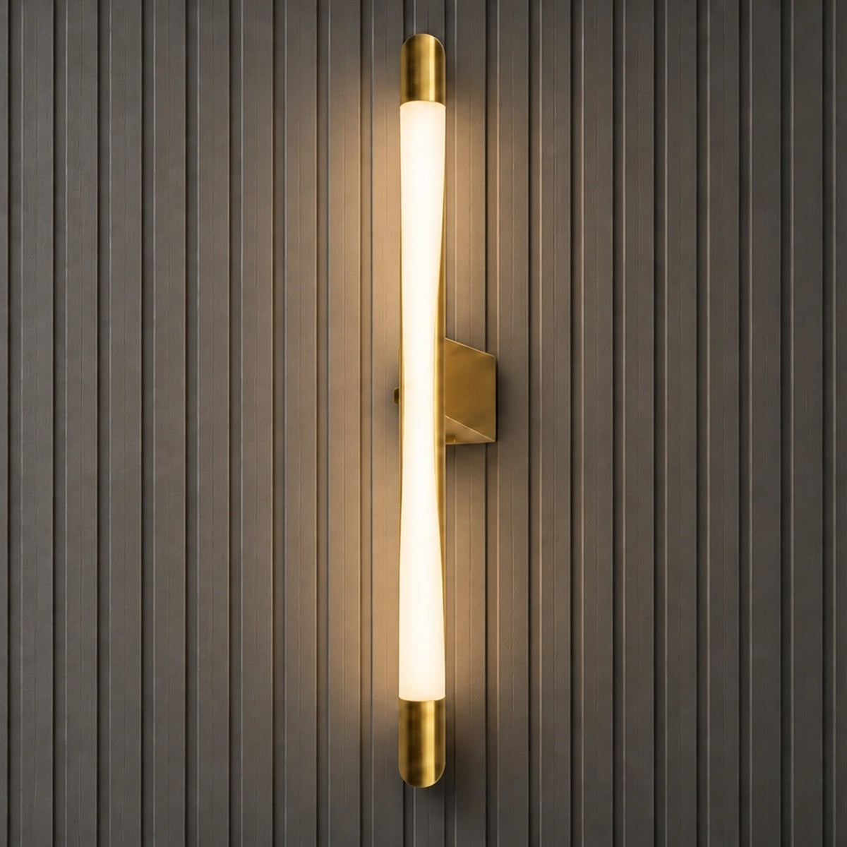 Square product view of the Serein curved vertical LED wall light illuminated on a dark fluted wall