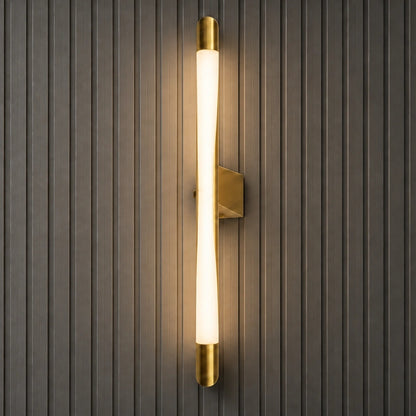 Square product view of the Serein curved vertical LED wall light illuminated on a dark fluted wall