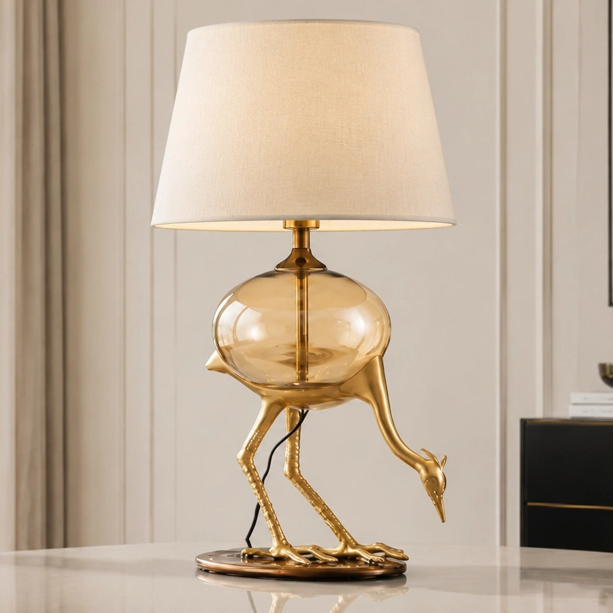Aurelia gold-tone crane table lamp unlit in a second bright interior view