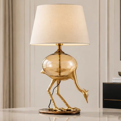 Aurelia gold-tone crane table lamp unlit in a second bright interior view