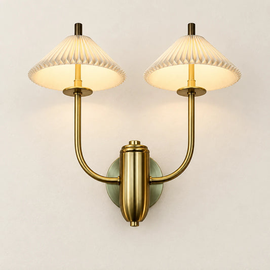Twin pleated cone-shade wall sconce on a clean studio background