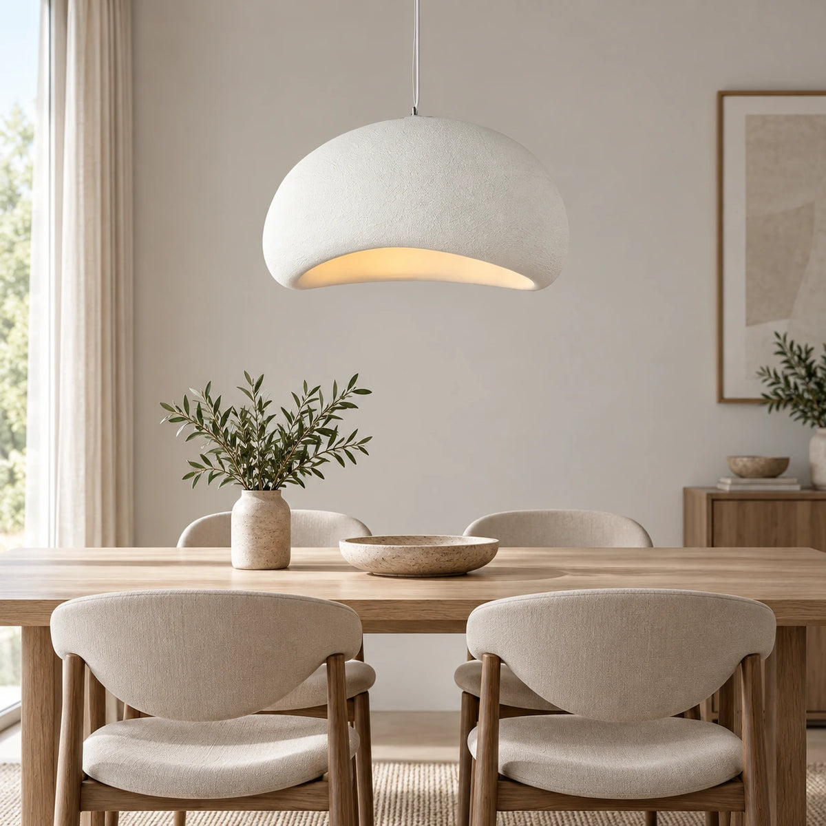 White textured curved dome pendant in a refined dining setting
