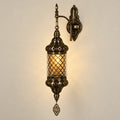 Antique mesh-globe wall sconce on a warm neutral background