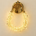 Faceted loop decorative wall light on a warm ivory wall