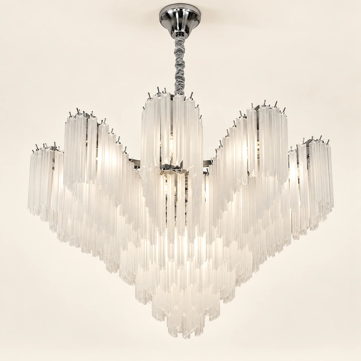 Frosted tiered chandelier on a warm ivory background