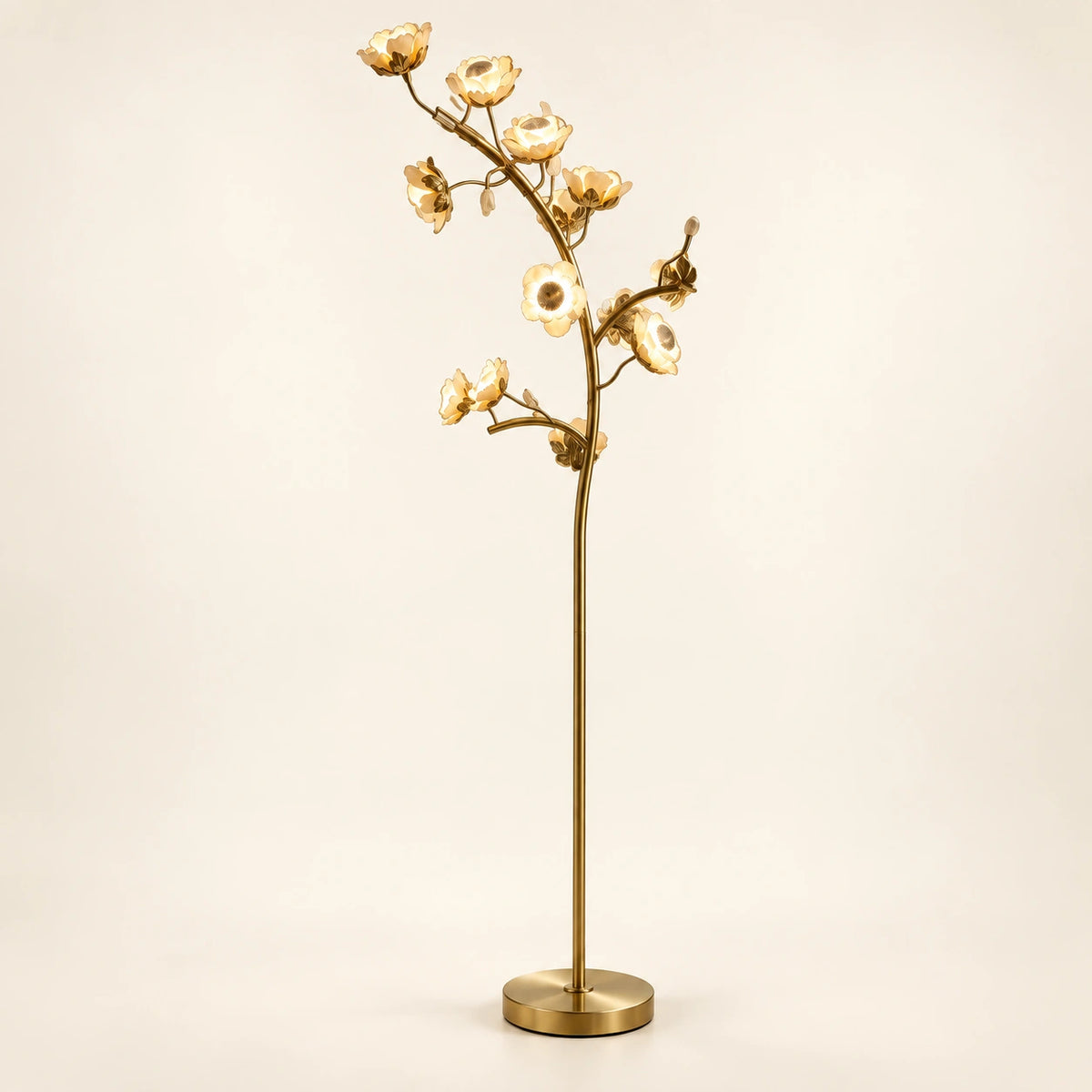 Sculptural floral branch floor lamp on a warm ivory background