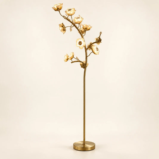 Sculptural floral branch floor lamp on a warm ivory background