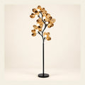 Branching globe floor lamp on a warm studio background