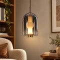 Smoke capsule glass pendant in a warm reading corner