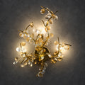 Illuminated floral-branch wall sculpture on a charcoal background