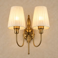 Twin pleated-shade wall sconce on a warm neutral background