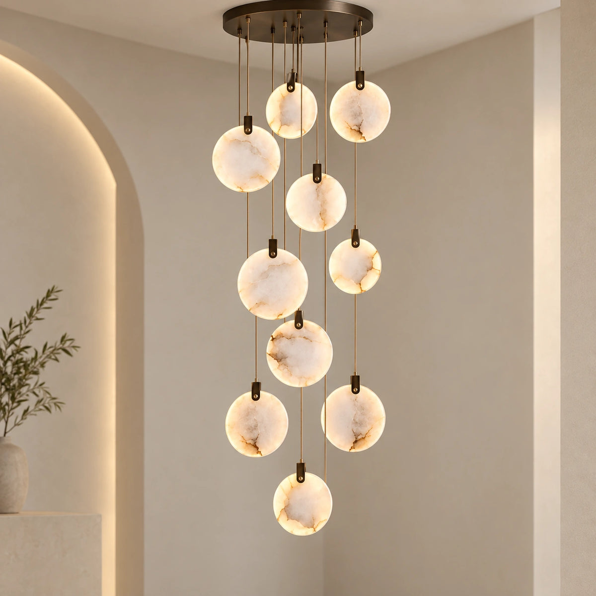 Ten-disc illuminated marble cascade chandelier in a tall interior