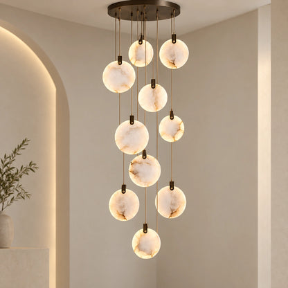 Ten-disc illuminated marble cascade chandelier in a tall interior