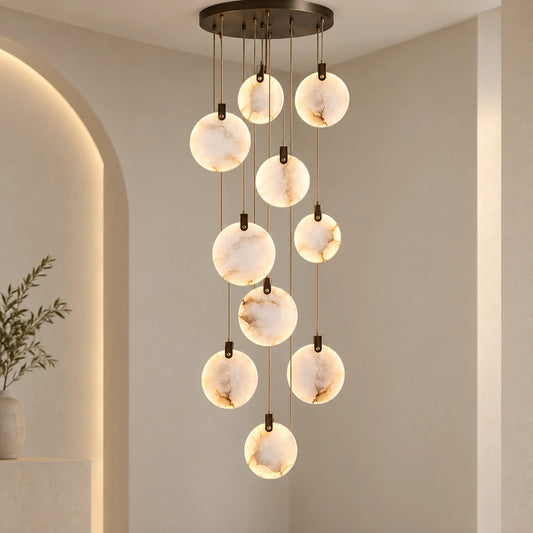 Ten-disc illuminated marble cascade chandelier in a tall interior