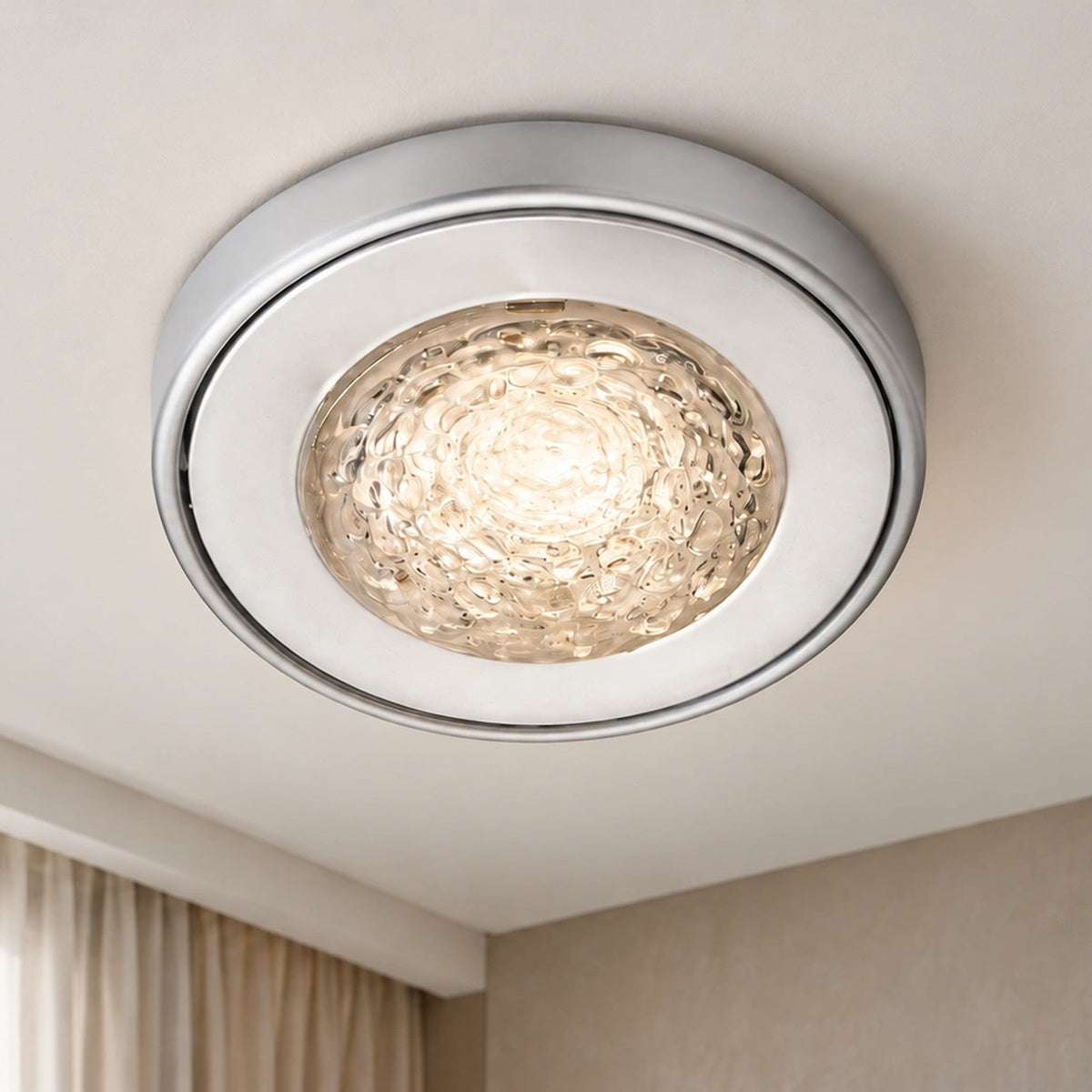 Silver textured glass ceiling light illuminated in a contemporary room