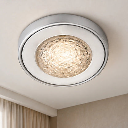 Silver textured glass ceiling light illuminated in a contemporary room